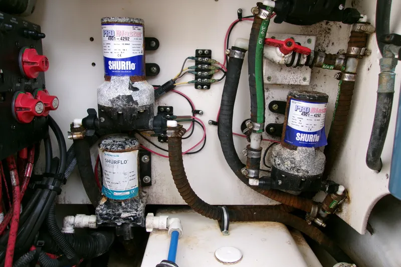 Slide: The Image of Electrical and plumbing components inside a 2010 Robalo R240 Center Console boat. - 16