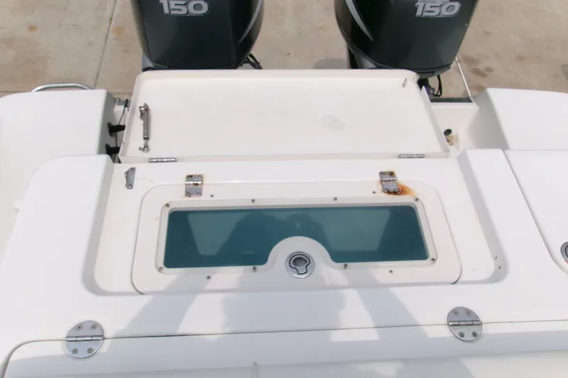 Slide: The Image of 2010 Robalo R240 Center Console boat with dual 150 engines and storage compartment. - 20