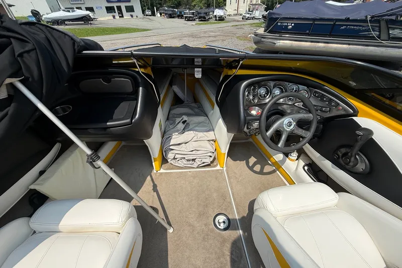 Slide: The Image of Interior of a 2007 Crownline 21 SS boat with steering wheel and seating. - 28