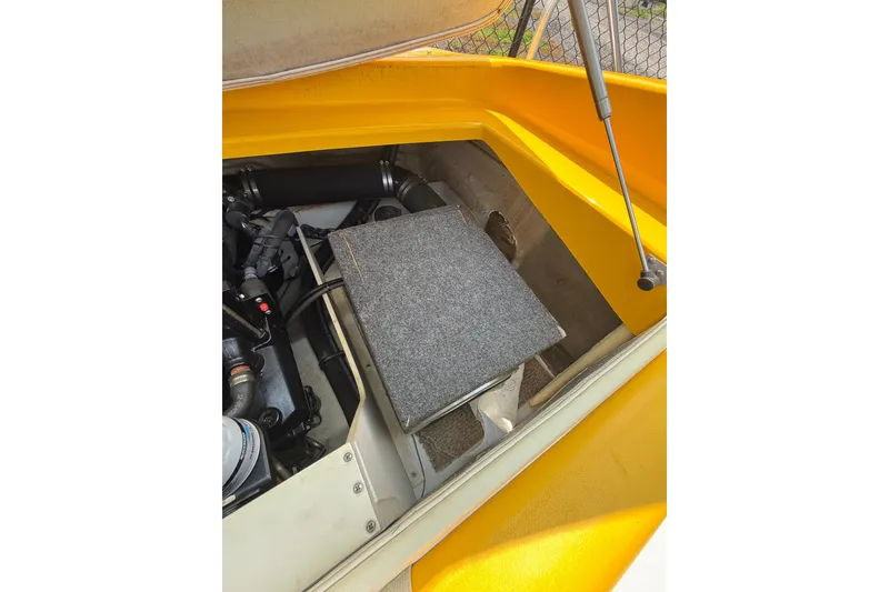 Slide: The Image of Engine compartment of a 2007 Crownline 21 SS boat, featuring a yellow exterior. - 35