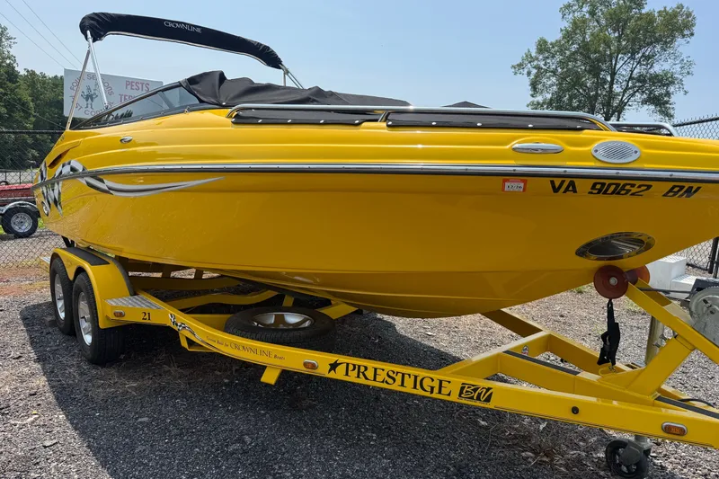 Slide: The Image of Yellow 2007 Crownline 21 SS boat on trailer, parked outdoors. - 4