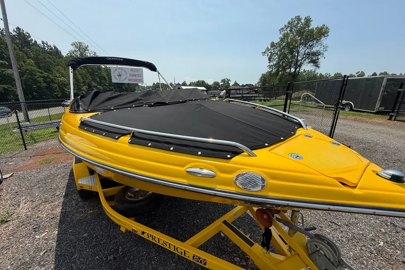 Slide: The Image of Yellow 2007 Crownline 21 SS boat on trailer, covered and parked outdoors. - 16
