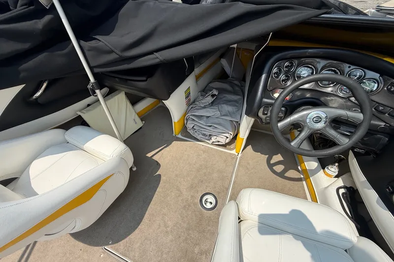 Slide: The Image of Interior of a 2007 Crownline 21 SS boat, featuring steering wheel and seating. - 27