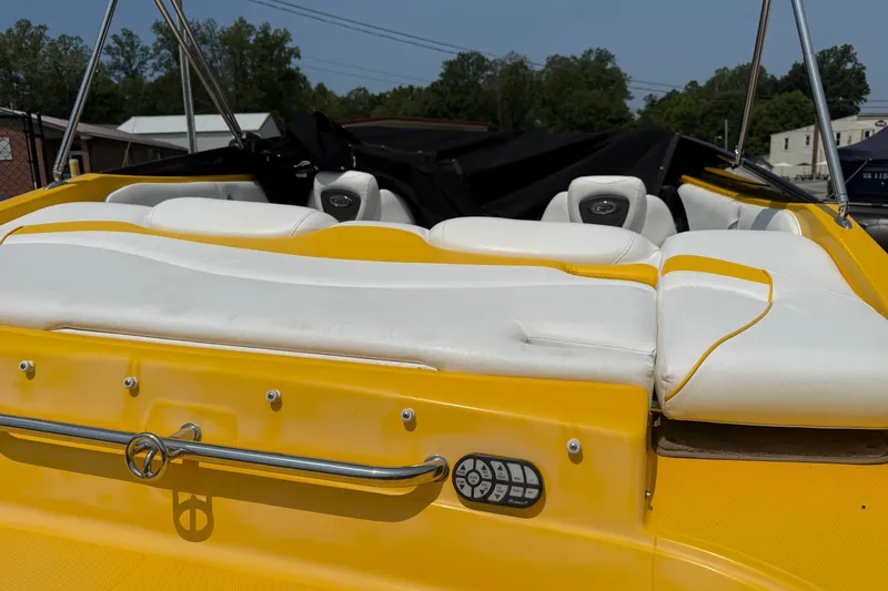 Slide: The Image of 2007 Crownline 21 SS boat with yellow and white seating, docked outdoors. - 12