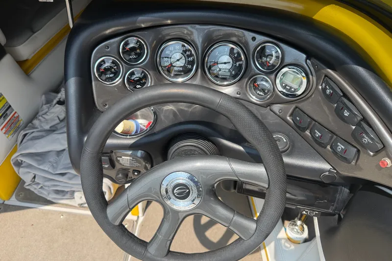 Slide: The Image of Dashboard of a 2007 Crownline 21 SS boat with gauges and steering wheel. - 25
