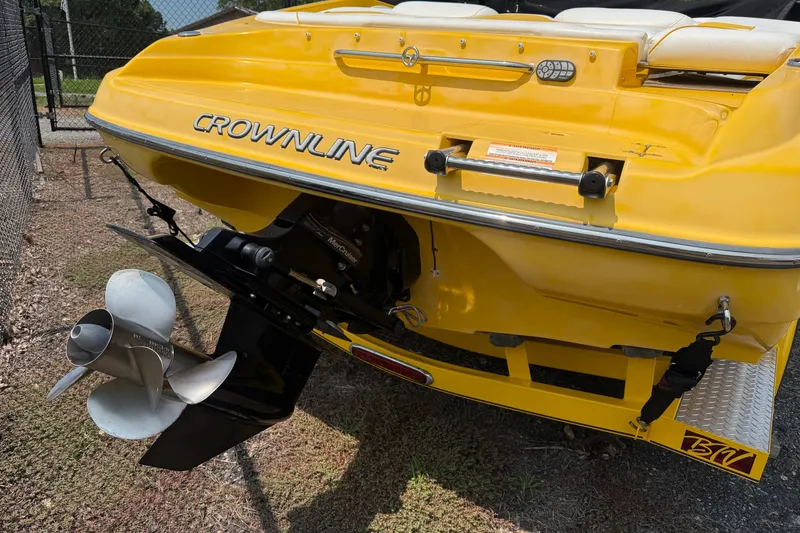 Slide: The Image of Yellow 2007 Crownline 21 SS boat rear view with propeller and branding. - 8
