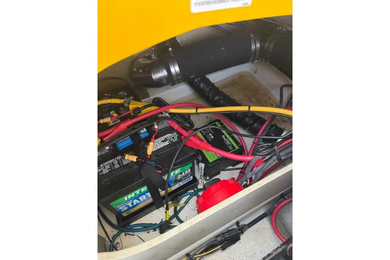 Slide: The Image of Battery compartment of a 2007 Crownline 21 SS boat with wiring and components. - 33