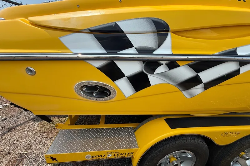 Slide: The Image of Yellow 2007 Crownline 21 SS boat with checkered flag design on trailer. - 7