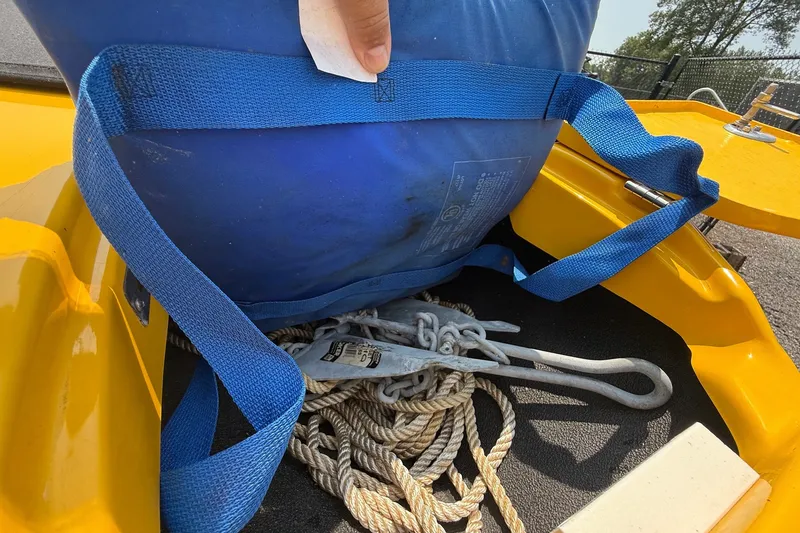 Slide: The Image of Blue strap securing equipment on 2007 Crownline 21 SS boat, with ropes and anchor visible. - 18