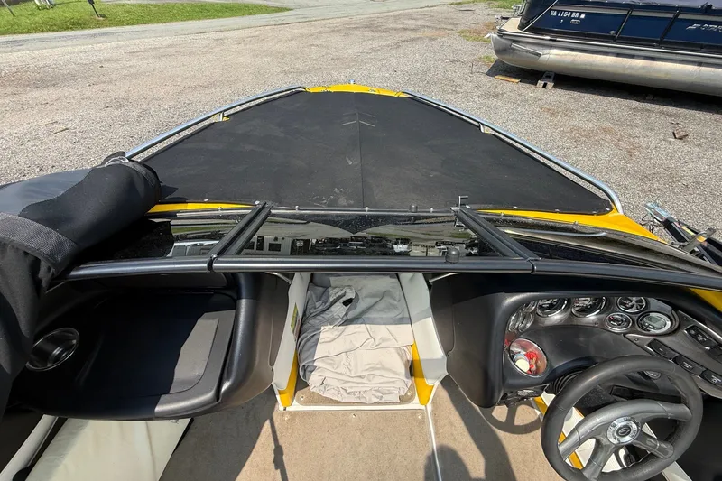 Slide: The Image of 2007 Crownline 21 SS boat interior with dashboard and steering wheel, parked on gravel. - 29