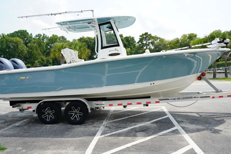 The Image of 2022 Sea Hunt Gamefish 25 boat on trailer, parked outdoors, side view. - 1