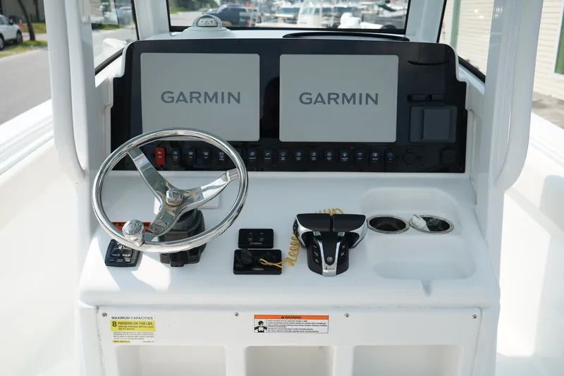 Slide: The Image of 2022 Sea Hunt Gamefish 25 helm with dual Garmin displays and steering wheel. - 9