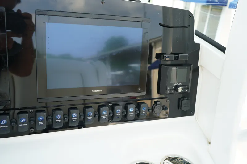 Slide: The Image of 2022 Sea Hunt Gamefish 25 dashboard with Garmin display and JL Audio system. - 11