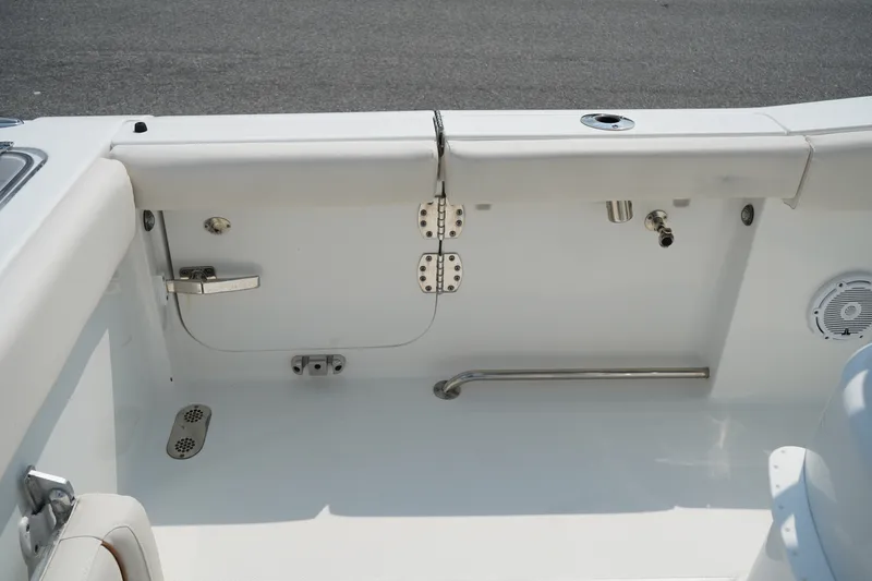Slide: The Image of 2022 Sea Hunt Gamefish 25 boat interior, featuring clean white seating and stainless steel fixtures. - 13