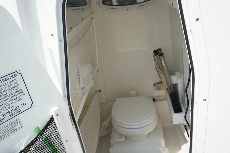 Slide: The Image of 2022 Sea Hunt Gamefish 25 boat interior with compact marine toilet. - 16