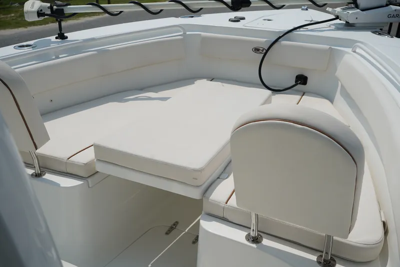 Slide: The Image of 2022 Sea Hunt Gamefish 25 boat interior with cushioned seating and fishing equipment. - 4