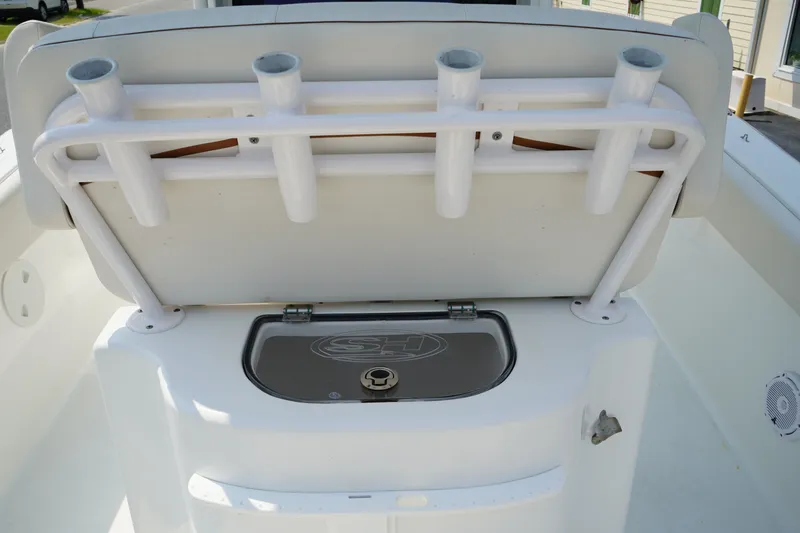 Slide: The Image of 2022 Sea Hunt Gamefish 25 boat with rod holders and storage compartment. - 17