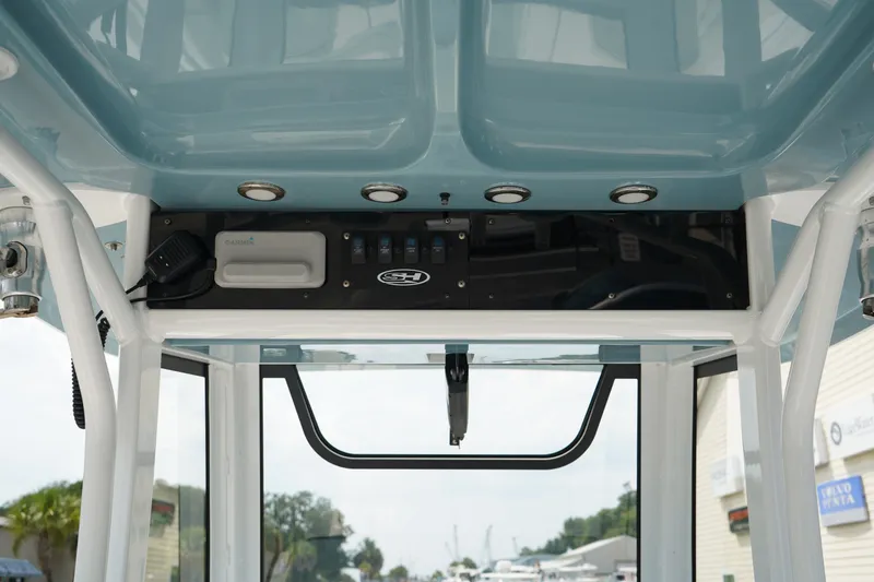 Slide: The Image of 2022 Sea Hunt Gamefish 25 boat console with controls and overhead lighting. - 10