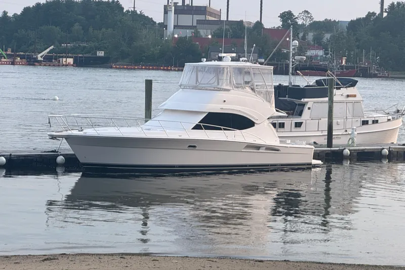 The Image of 2009 Riviera 45 Open Flybridge yacht docked by the waterfront. - 0
