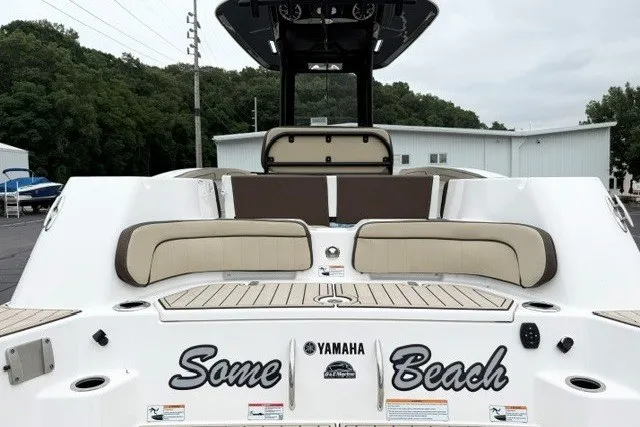 Slide: The Image of 2024 Yamaha Boats 255 FSH Sport H, rear view with seating and "Some Beach" text. - 8