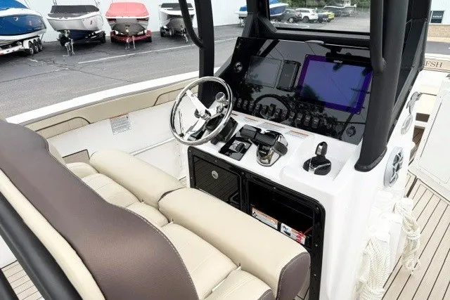Slide: The Image of 2024 Yamaha Boats 255 FSH Sport H cockpit with modern controls and comfortable seating. - 15
