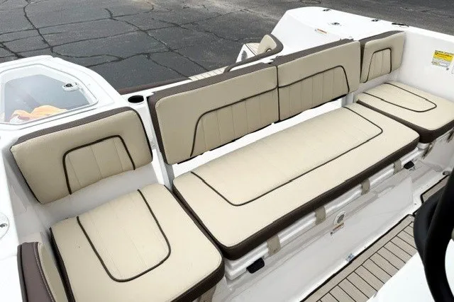 Slide: The Image of 2024 Yamaha Boats 255 FSH Sport H interior seating with beige cushions and sleek design. - 17