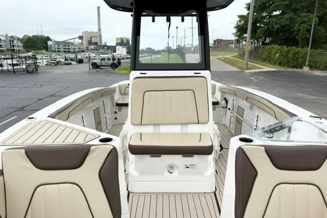 Slide: The Image of 2024 Yamaha Boats 255 FSH Sport H interior with beige seating and modern design. - 11