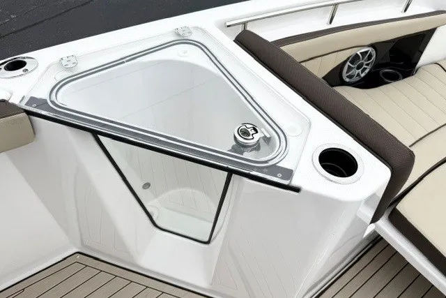 Slide: The Image of 2024 Yamaha Boats 255 FSH Sport H interior with seating and storage compartment. - 14