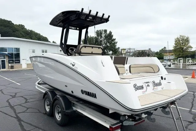 Slide: The Image of 2024 Yamaha Boats 255 FSH Sport H on trailer, parked outdoors. - 3