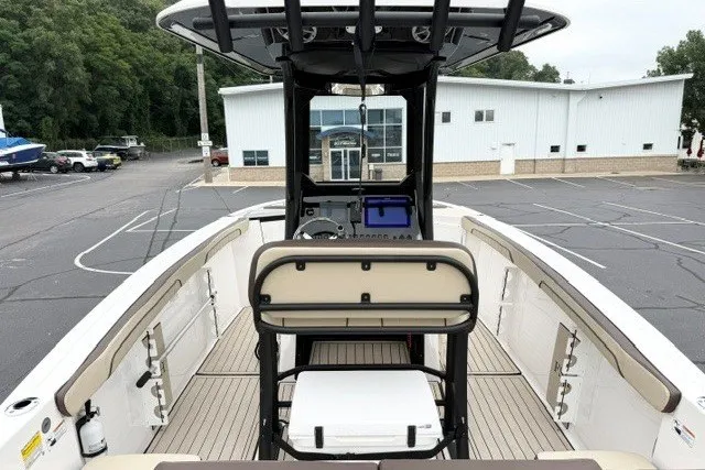 Slide: The Image of 2024 Yamaha Boats 255 FSH Sport H, center console view, in a parking lot. - 7