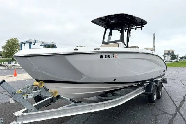 The Image of 2024 Yamaha Boats 255 FSH Sport H on trailer, parked outdoors. - 0