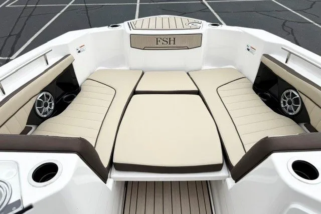 Slide: The Image of 2024 Yamaha Boats 255 FSH Sport H interior with beige seating and cup holders. - 12