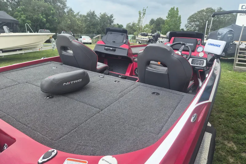 Slide: The Image of Red 2021 Nitro Z20 fishing boat interior with dual seats and navigation equipment. - 7