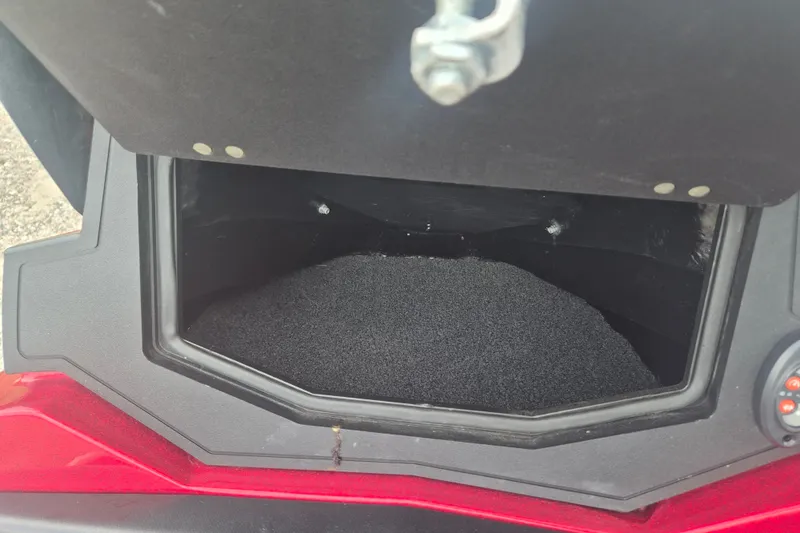 Slide: The Image of Open storage compartment of 2021 Nitro Z20 boat, featuring black interior lining. - 15