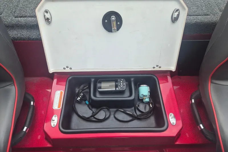 Slide: The Image of Open storage compartment in a 2021 Nitro Z20 boat with electronic equipment inside. - 11