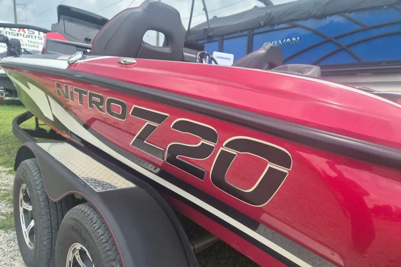 Slide: The Image of Red 2021 Nitro Z20 boat with bold branding, parked on a trailer. - 3
