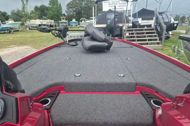 Slide: The Image of Red 2021 Nitro Z20 boat deck with seating, surrounded by other boats in a yard. - 19