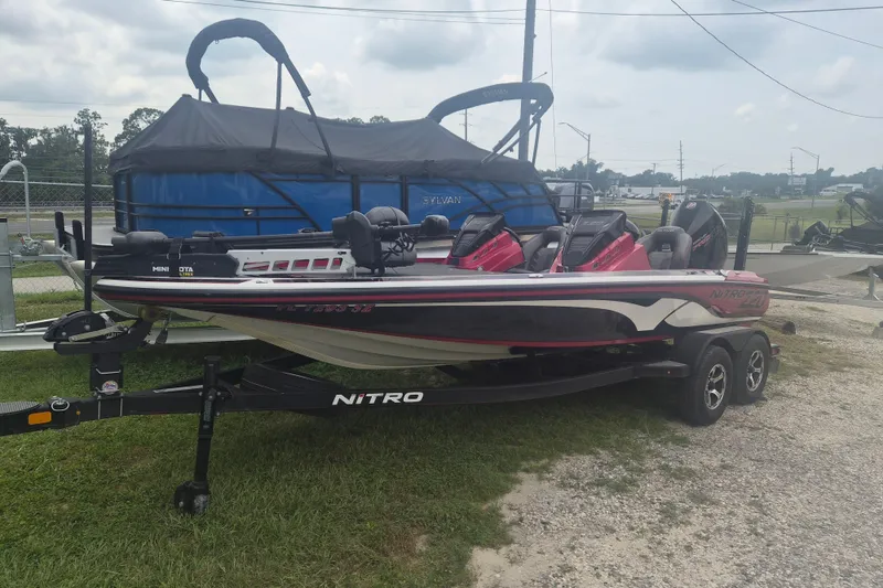 The Image of 2021 Nitro Z20 boat on trailer, parked outdoors, featuring sleek design and vibrant colors. - 1