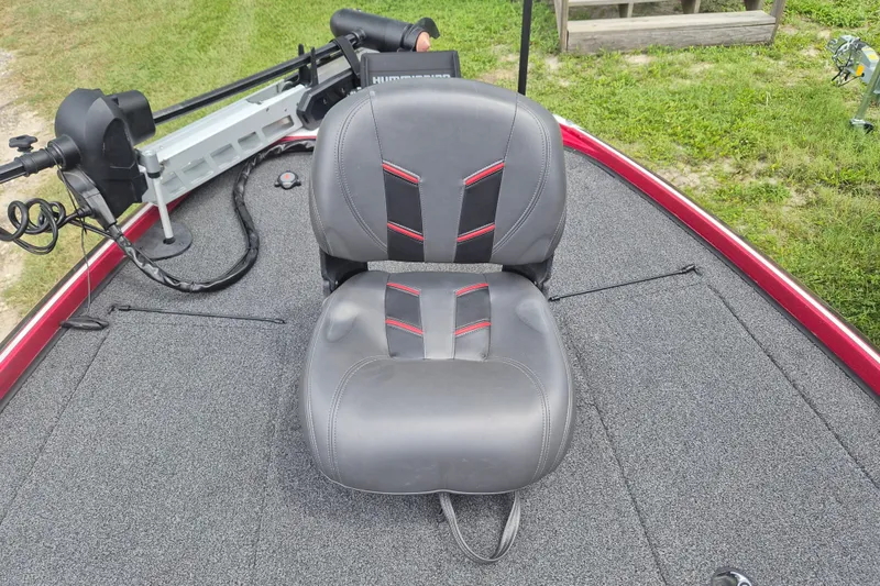 Slide: The Image of 2021 Nitro Z20 boat seat with gray upholstery and red accents on a carpeted deck. - 24