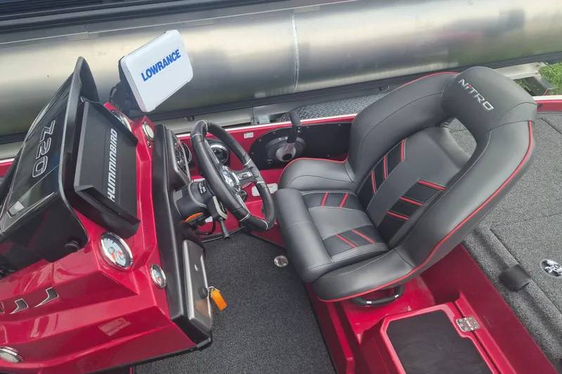 Slide: The Image of 2021 Nitro Z20 boat cockpit with steering wheel, Hummingbird and Lowrance displays, and cushioned seat. - 12