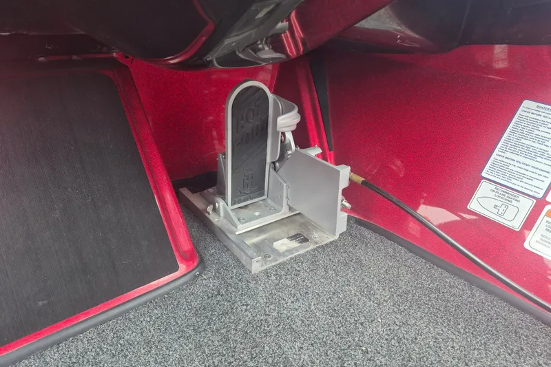 Slide: The Image of Foot pedal mechanism in a 2021 Nitro Z20 boat, featuring red interior and safety instructions. - 18