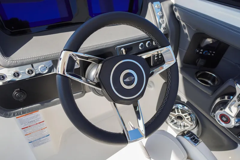 Slide: The Image of Steering wheel of 2026 Chaparral 270 OSX boat, featuring modern controls and sleek design. - 62