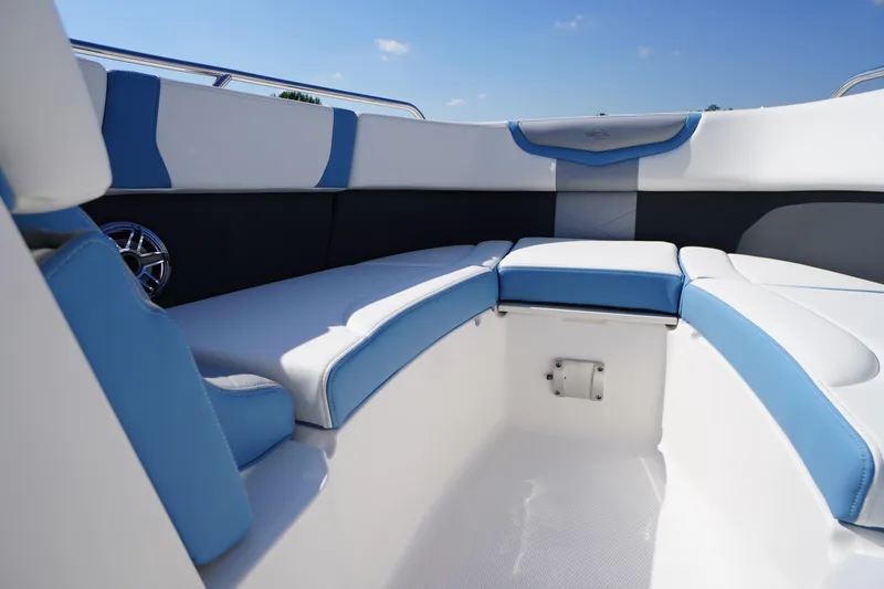 Slide: The Image of 2026 Chaparral 270 OSX boat interior with blue and white seating, showcasing modern design. - 10