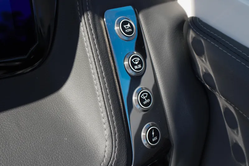 Slide: The Image of Control panel of 2026 Chaparral 270 OSX boat with horn, bilge, wiper, and accessory buttons. - 67