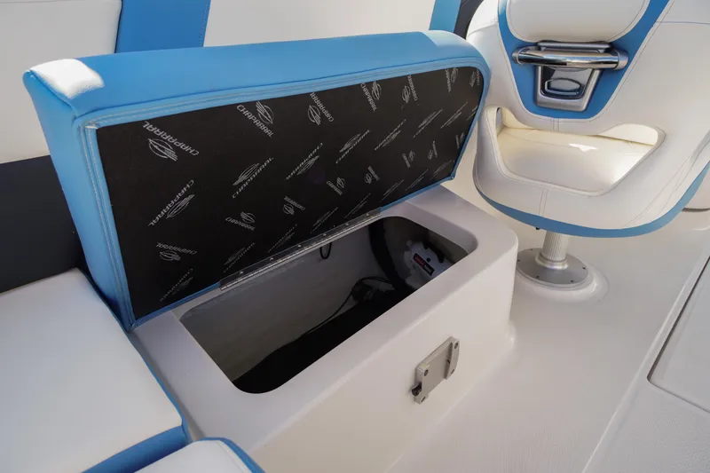 Slide: The Image of 2026 Chaparral 270 OSX boat interior with open storage compartment and blue-white seating. - 45