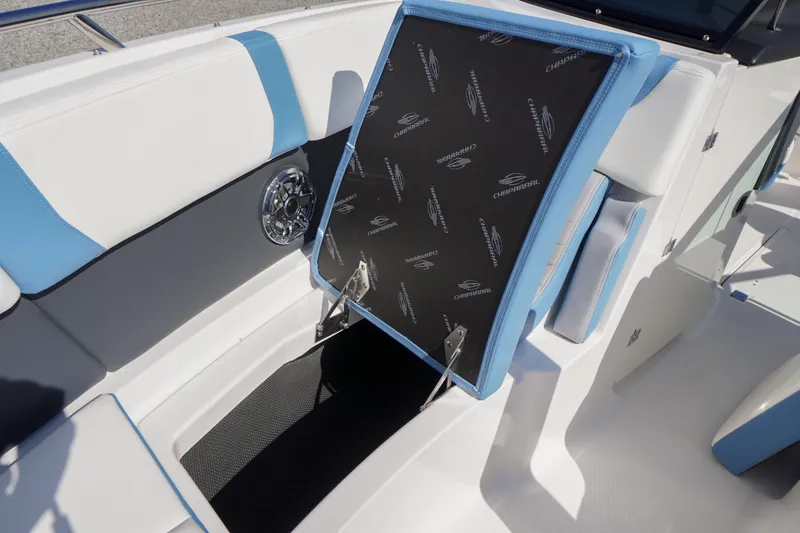 Slide: The Image of 2026 Chaparral 270 OSX boat interior with open storage compartment and stylish seating. - 14