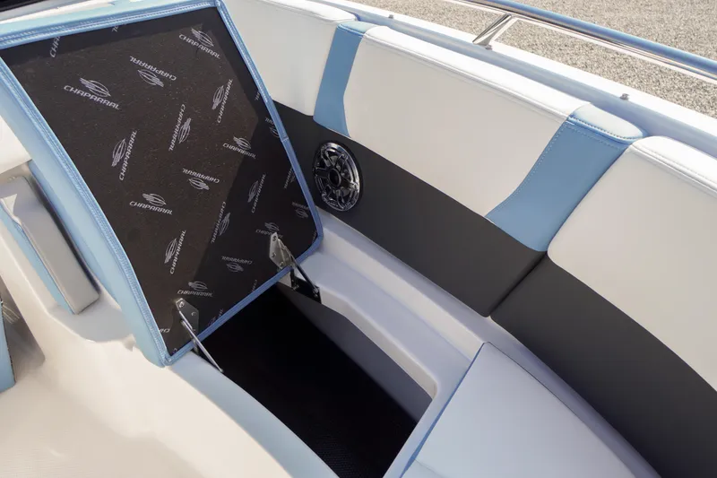 Slide: The Image of 2026 Chaparral 270 OSX boat interior with open storage compartment and speaker detail. - 15