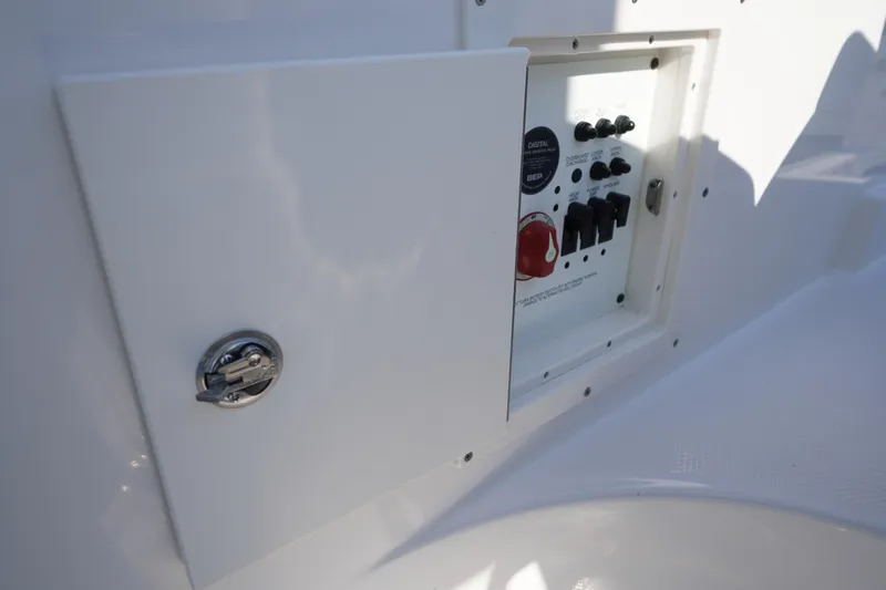 Slide: The Image of Control panel of 2026 Chaparral 270 OSX boat, featuring switches and a latch. - 54