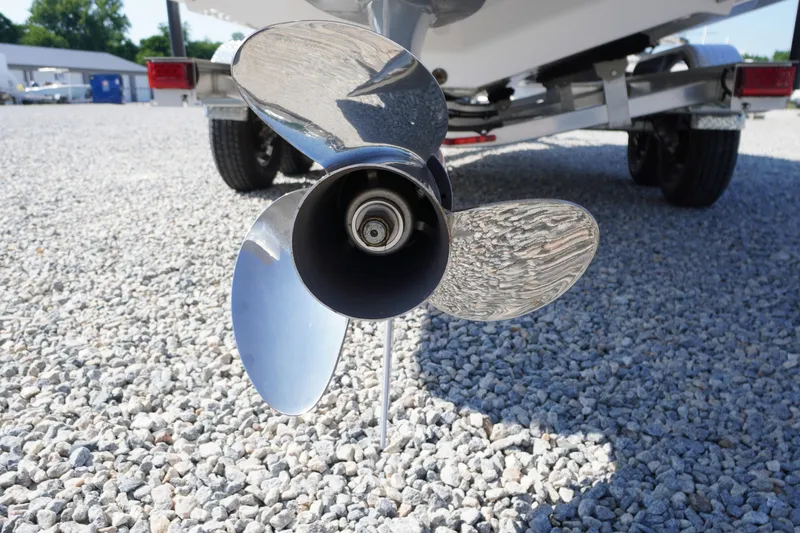 Slide: The Image of 2026 Chaparral 270 OSX boat propeller on gravel surface, close-up view. - 75