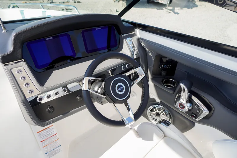 Slide: The Image of 2026 Chaparral 270 OSX boat dashboard with modern steering wheel and dual displays. - 61